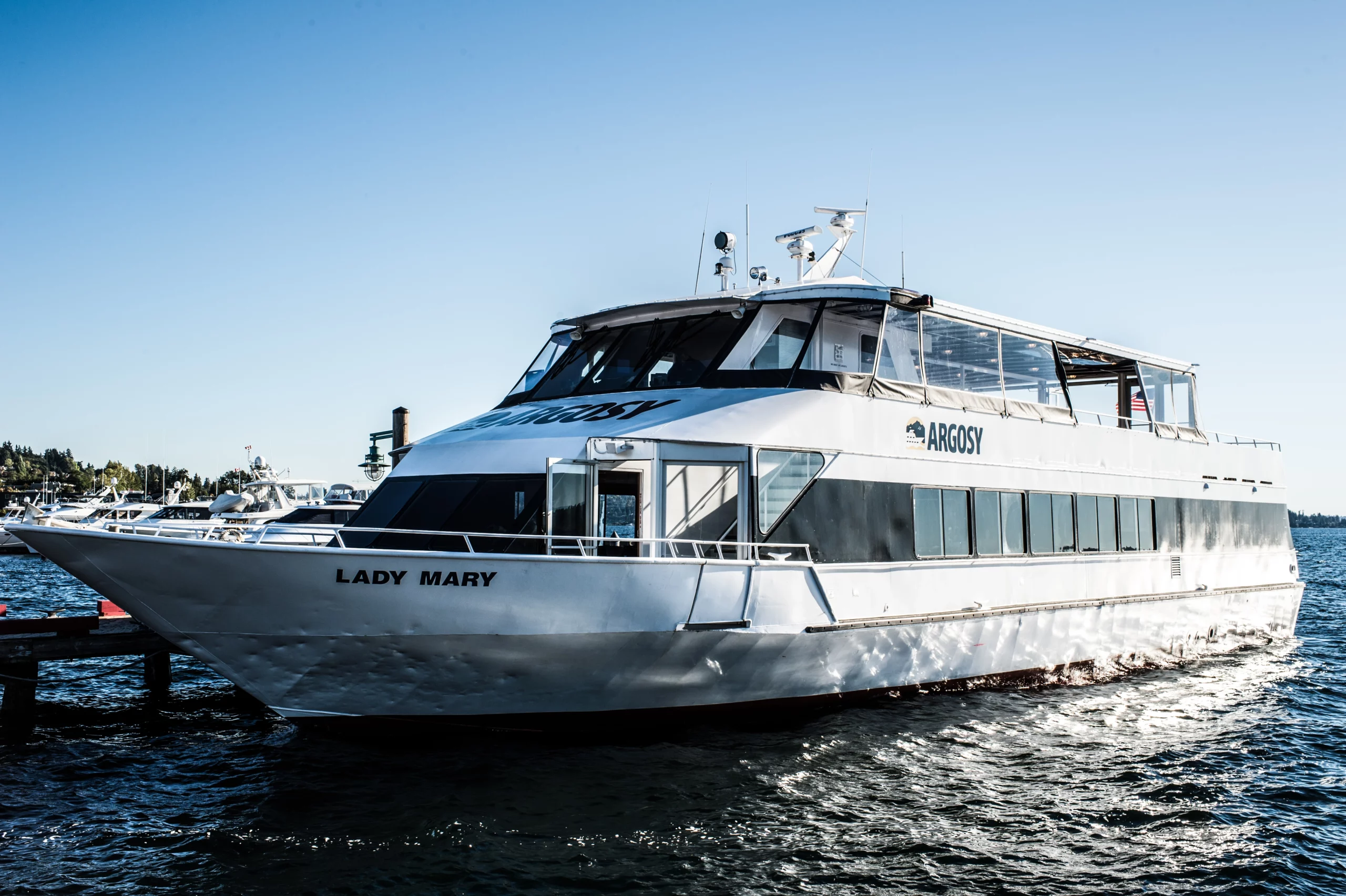 Photo of a white private charter boat on the water. It is named Lady Mary and has the Argosy Cruises branding on the side.